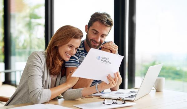 couple checking on their investments with Elliot Watson Financial Planning