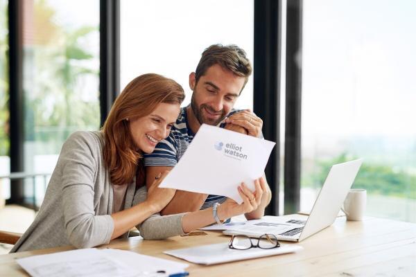 couple checking on their investments with Elliot Watson Financial Planning